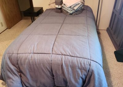 Twin Bed, bedding, lamp & side table